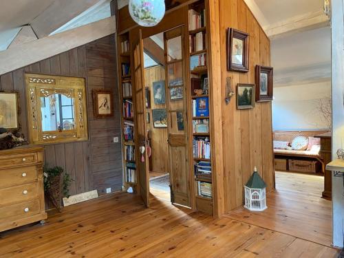 a room with wooden walls and wooden floors and a door at Cottage chaleureux avec piscine privée in Sainte Anastasie - Aubarne