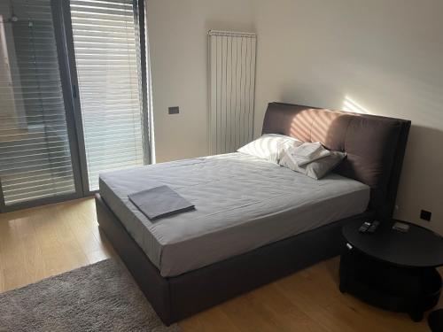 a bed in a bedroom with a large window at Downtown in Belgrade