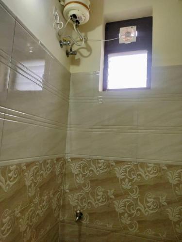 a bathroom with a shower with a window at Home to explore Food, History & Shopping in Hyderabad