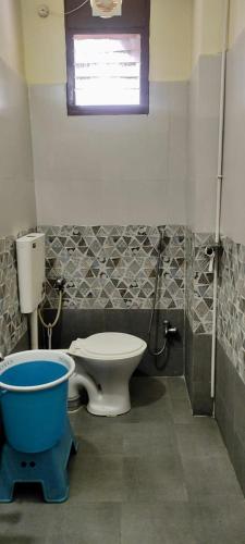 a bathroom with a toilet and a bath tub at Home to explore Food, History & Shopping in Hyderabad