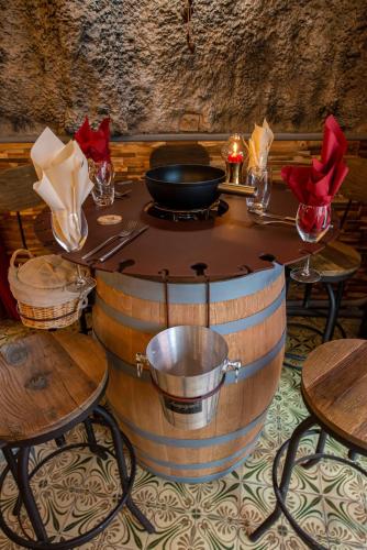 a wooden table with a bowl on top of a barrel at Auberge de la Paix in Briançon