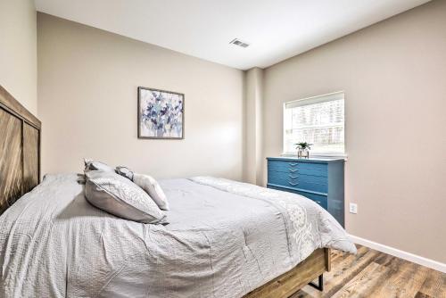 a bedroom with a bed and a blue dresser at Eureka Springs Area Home with Porch, Grill! in Berryville