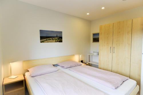 Postel nebo postele na pokoji v ubytování Am Sahlenburger Strand AS10