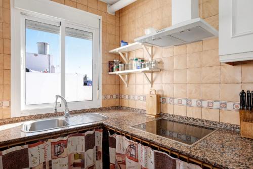 a kitchen with a sink and a window at Apartamento Goya in Conil de la Frontera