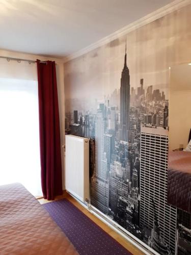 a bedroom with a window with a view of the city at Apartment Carmen in Nachdemsee