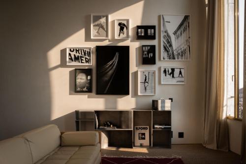 a living room with a couch and pictures on the wall at The Venice Venice Hotel in Venice