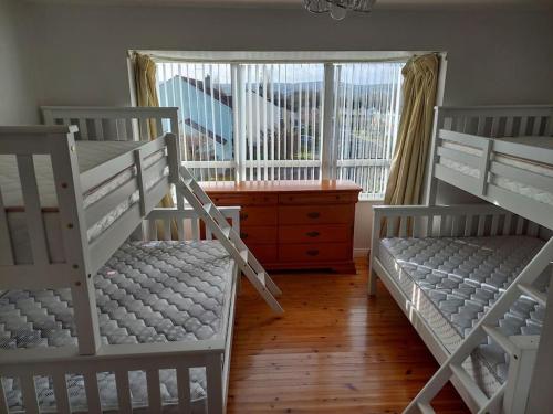 a room with two bunk beds and a window at Kool 12 bed house in Letterkenny TowN in Letterkenny