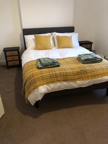 a bedroom with a large bed with yellow pillows at River Terrace in Lancaster