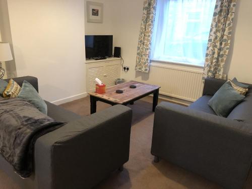 a living room with two couches and a coffee table at River Terrace in Lancaster