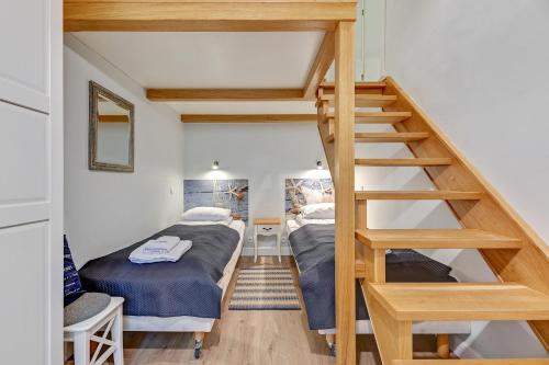 a bedroom with a bunk bed and a staircase at K2018 Mezzo Grand Tourist Apartments in Gdańsk