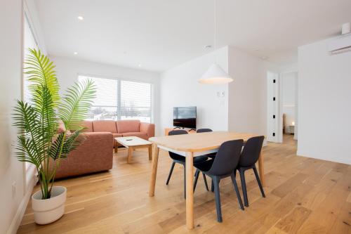 a living room with a table and chairs and a couch at Les Lofts St-François - Par Les Lofts Vieux-Quebec in Quebec City