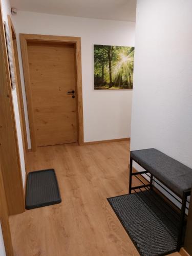 a hallway with a door and a bench in a room at Ferienwohnung Frieda in Ellmau