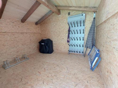 a room with a black bag and a wall at Ferienwohnung Frieda in Ellmau