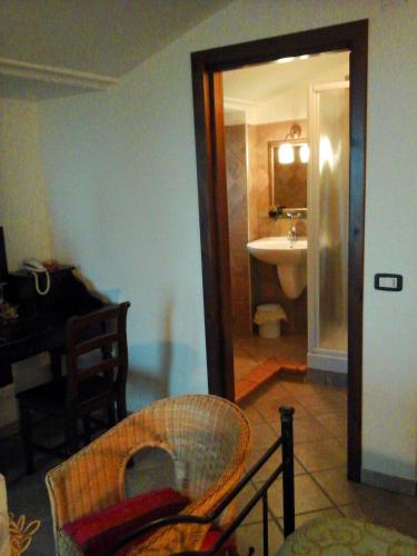 a room with a bathroom with a sink and a table at B&B La Civetta in Agropoli