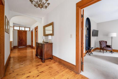 a living room with a table and a mirror at Stratton Creek Inn in Stratton