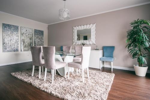 a dining room with a glass table and chairs at Casa Branca in Funchal