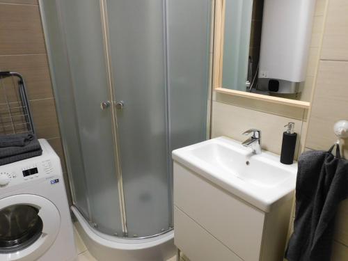 a bathroom with a shower and a toilet and a sink at Chill & Relax Apartment in Siófok