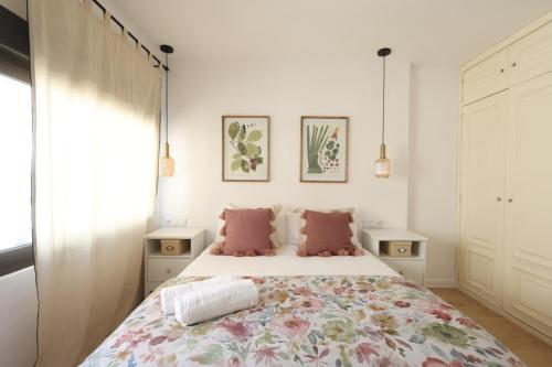 a bedroom with a large bed with pink pillows at FLORIT FLATS - The Apolo Apartment in Valencia