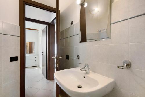 a bathroom with a sink and a mirror at Bilocale Serra in Bonassola
