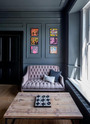 a living room with a couch and a coffee table at Coed Mawr Hall Bed & Breakfast in Conwy