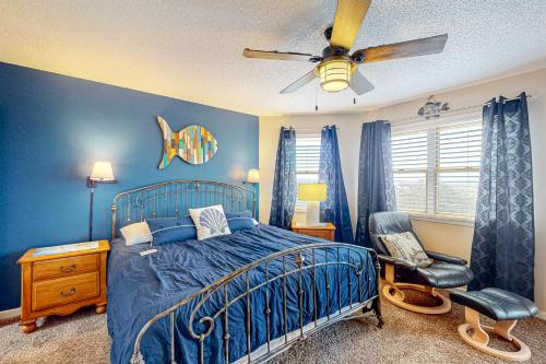 a bedroom with a bed and a ceiling fan at Castle in the Sand 453 in Avon