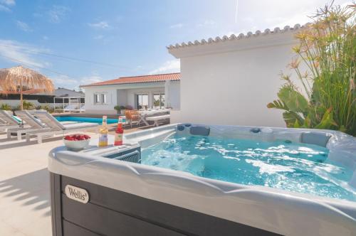 a hot tub in the backyard of a house at Villa Sound of the Sea by Portugal Collection in Aljezur