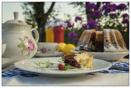 a piece of cake on a plate on a table at Dom Pod Lipami in Blatnica