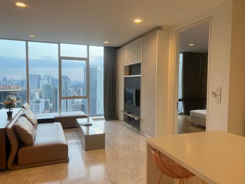 a large living room with a view of a city at Platinum Suites KLCC by MoonOrchid in Kuala Lumpur