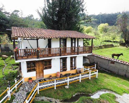 a model of a house with a deck at La Posada Campestre Cabañas in El Cocuy