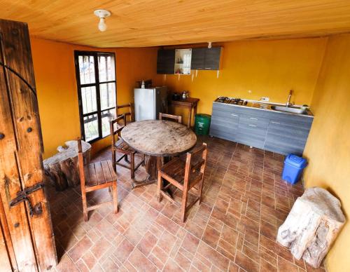 a kitchen with a table and chairs in a room at La Posada Campestre Cabañas in El Cocuy