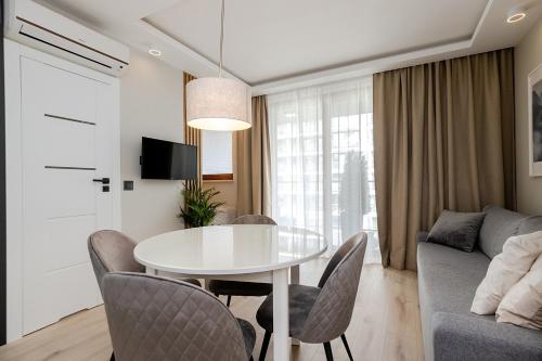 a living room with a white table and chairs at Apartment Wola, WI-FI, Smart Lock, Air Condition in Warsaw