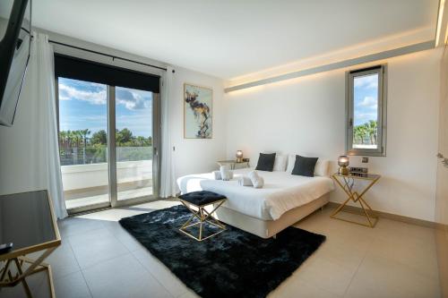 a bedroom with a bed and a large window at Es Maiols Casa A in Can Furnet
