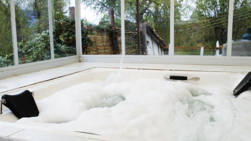 a bathtub filled with snow in front of a window at La Posada Campestre Cabañas in El Cocuy