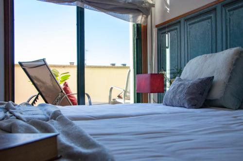 a bedroom with a large bed and a large window at Luxury Singular Apartments Green in Santiago de Compostela
