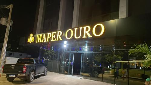 a truck parked in front of a mariper quico sign at Maper Ouro in Parauapebas