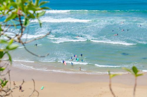 a group of people in the water at the beach at Villa Sound of the Sea by Portugal Collection in Aljezur