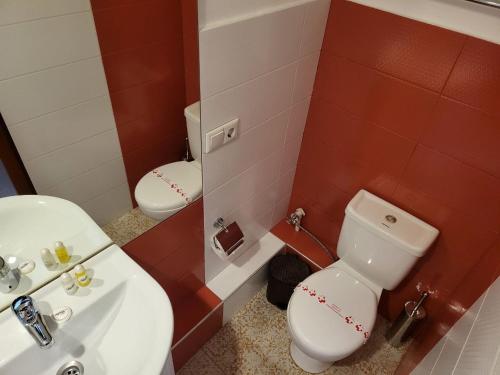 a bathroom with a white toilet and a sink at Shadow Boutique Hotel & SPA in Chişinău