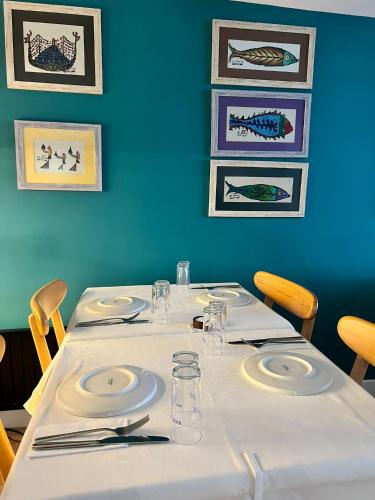 a table with white plates and napkins on it at Riva's Moda in Istanbul