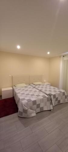 a bedroom with a large bed in a room at Rocha Apartment Plus in Portimão