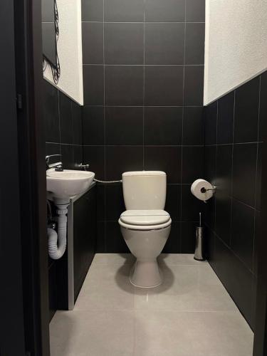 a bathroom with a toilet and a sink at Smart Hotel Budapest in Budapest