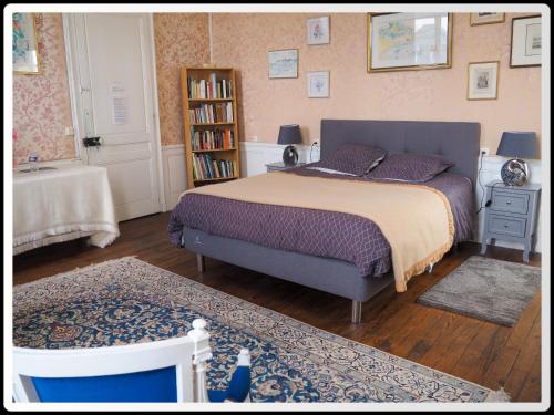 um quarto com uma cama e uma estante de livros em Fief des 3 Guillaume Chambres d'hôtes em Écouis