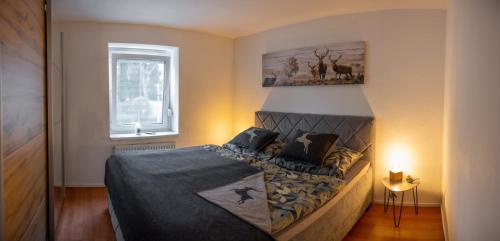 a bedroom with a bed with a picture on the wall at Garden Town Appartement in Salzburg