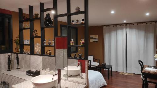 a bathroom with two sinks on a wall with shelves at Marie's Home in Saint-Péray