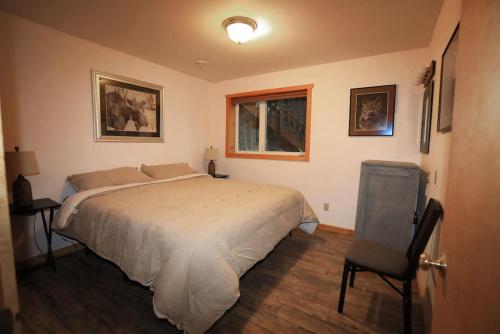 a bedroom with a bed and a window and a chair at 3 Bedroom Home with Amazing Views 11 mi from Denali in Healy