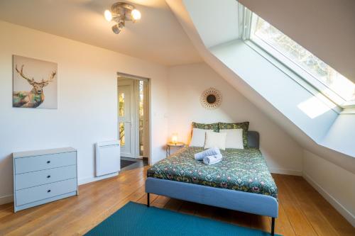 a bedroom with a bed and a window at Loft les deux cèdres avec vue panoramique in Charleville-Mézières