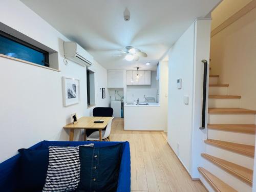 a living room with a blue couch and a table at One-Ikebukuro TS0230 in Tokyo