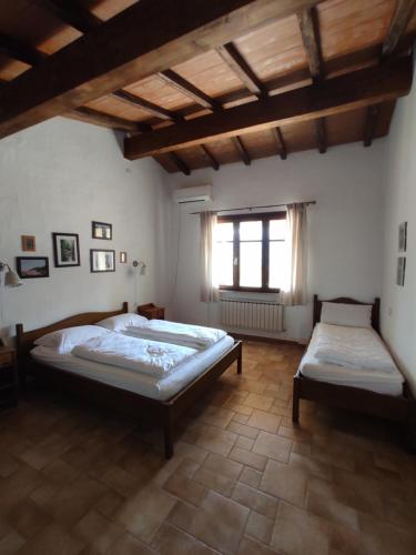 a bedroom with two beds and a window at Agriturismo Asara in Padru