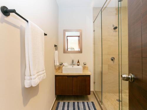 a bathroom with a sink and a shower at Sea Esta - Terra 194 in Cabo San Lucas