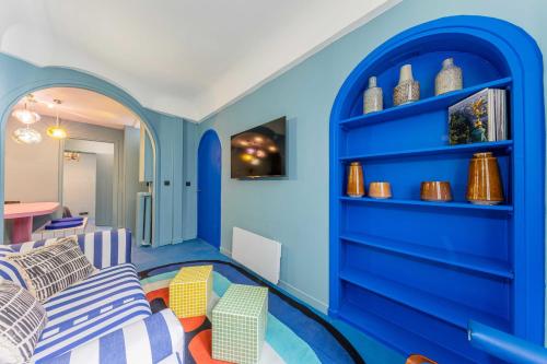 a blue room with a couch and chairs at Emblematic apartment 2BR6P Saint honoré Rivoli in Paris