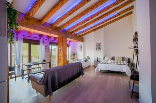 a bedroom with a bed with purple lights on the ceiling at Apartamento Villar in Alcalá del Júcar